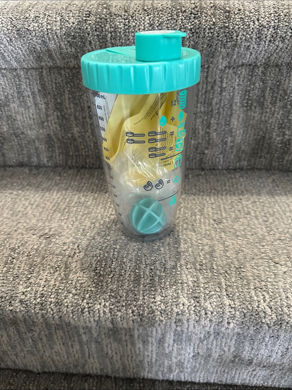 Pampered Chef pancake shaker bottle with a teal lid.